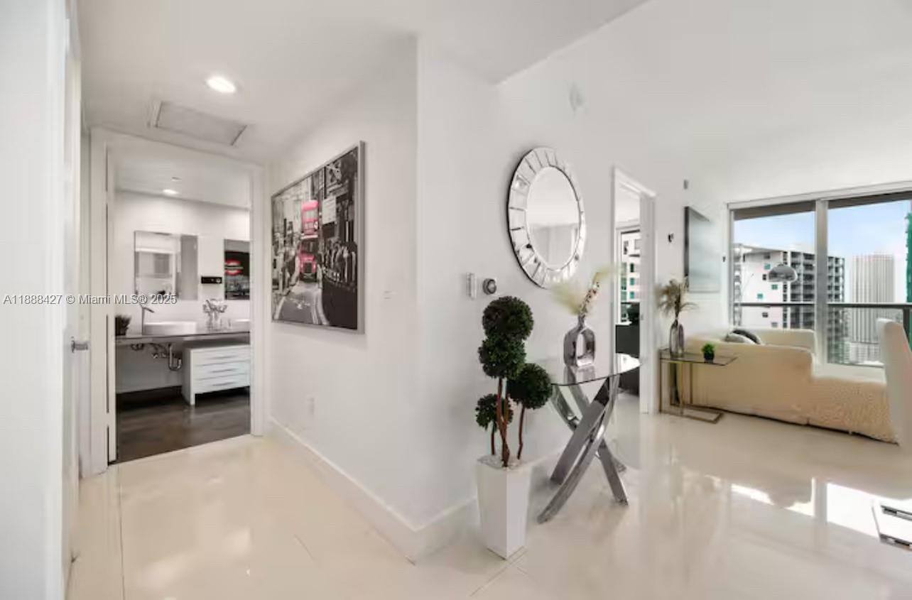 485 Brickell Avenue, Unit 3707 Miami, FL 33131 - Photo 9 of 41 a living room with furniture a rug and white walls