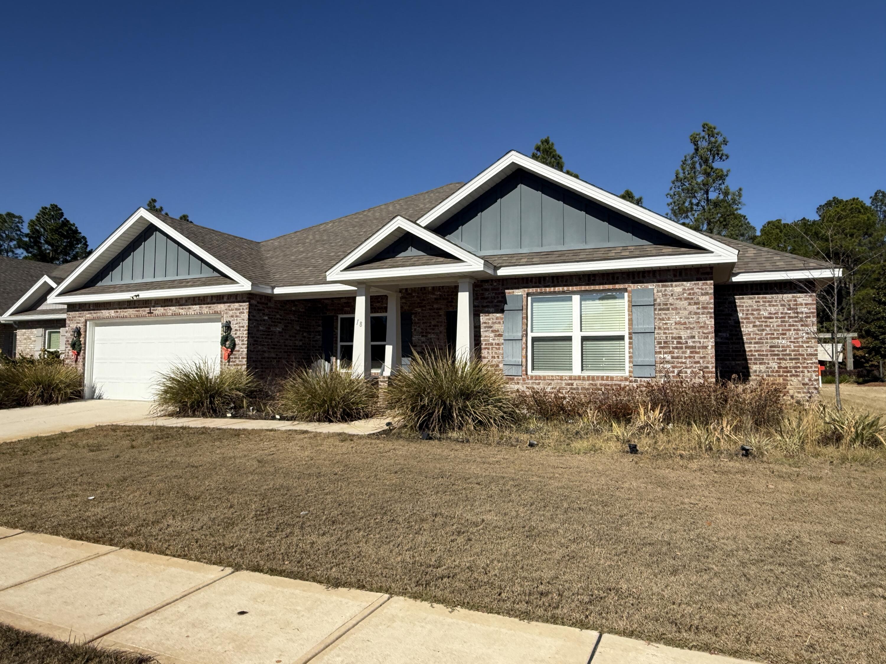 18 West Sky Way Freeport, FL 32439 - Photo 3 of 25 a front view of a house with a yard