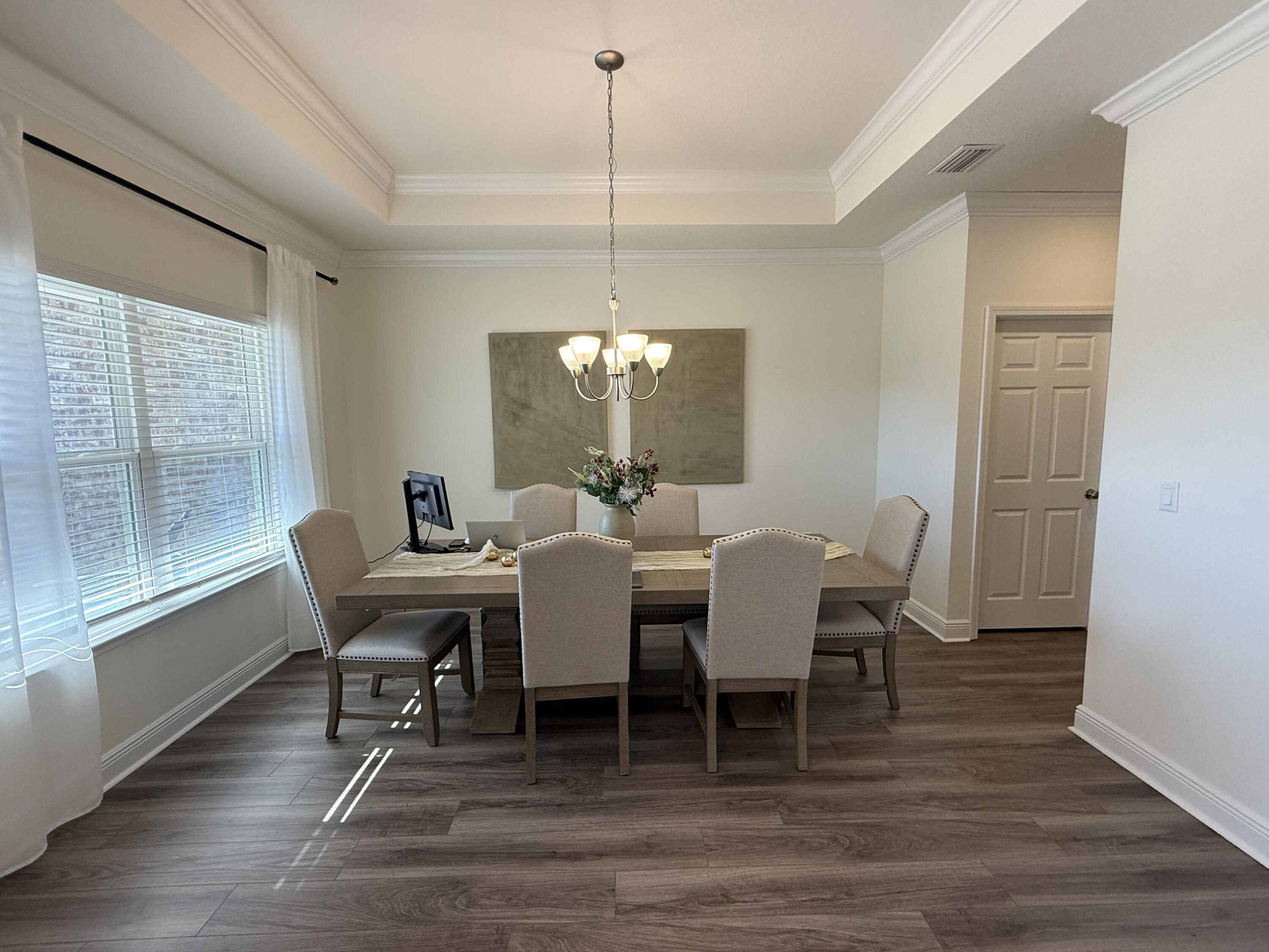18 West Sky Way Freeport, FL 32439 - Photo 5 of 25 a view of a dining room with furniture window and wooden floor