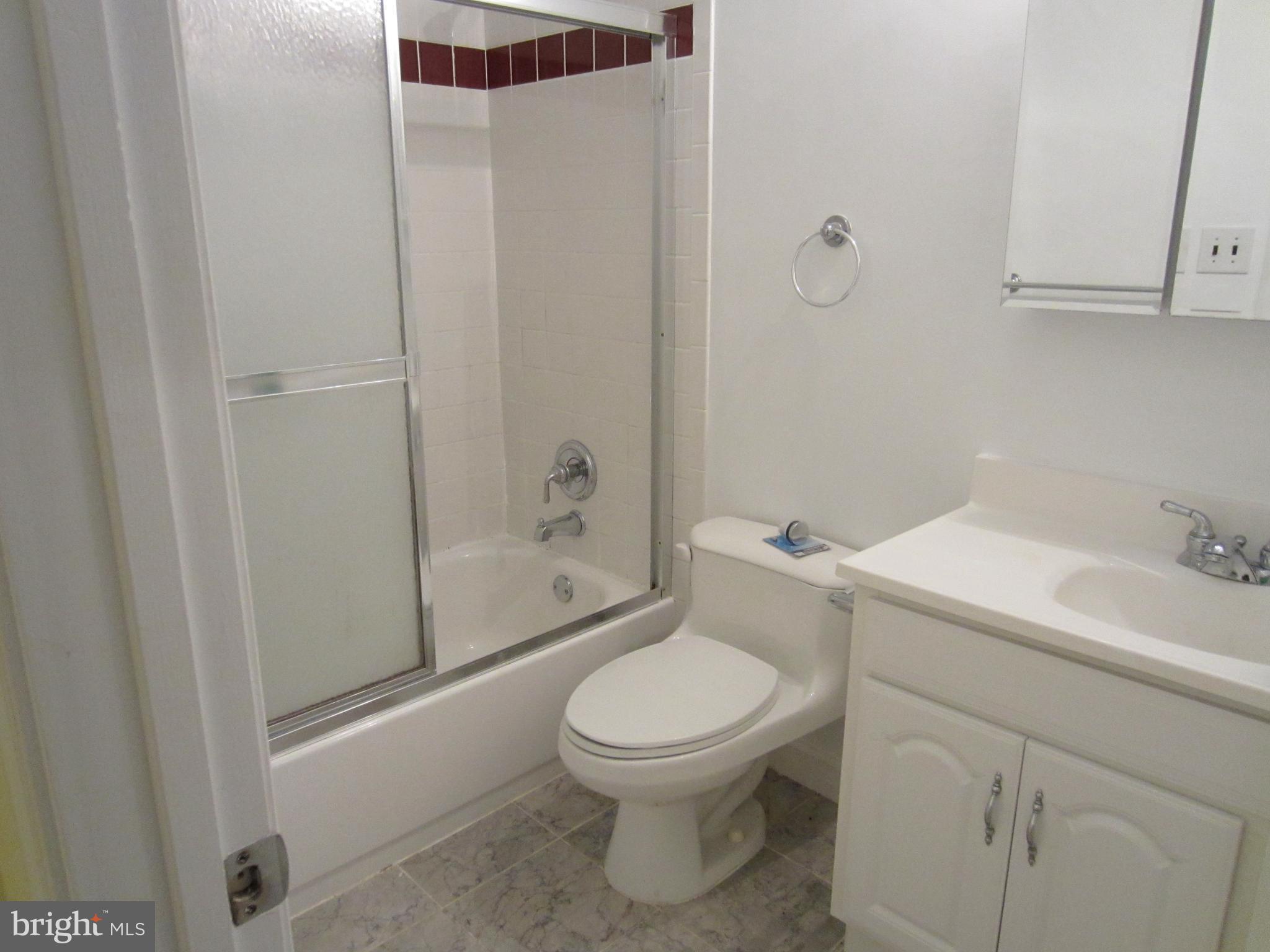 6486 Franconia Road Springfield, VA 22150 - Photo 11 of 16 a white toilet sitting next to a bathroom sink
