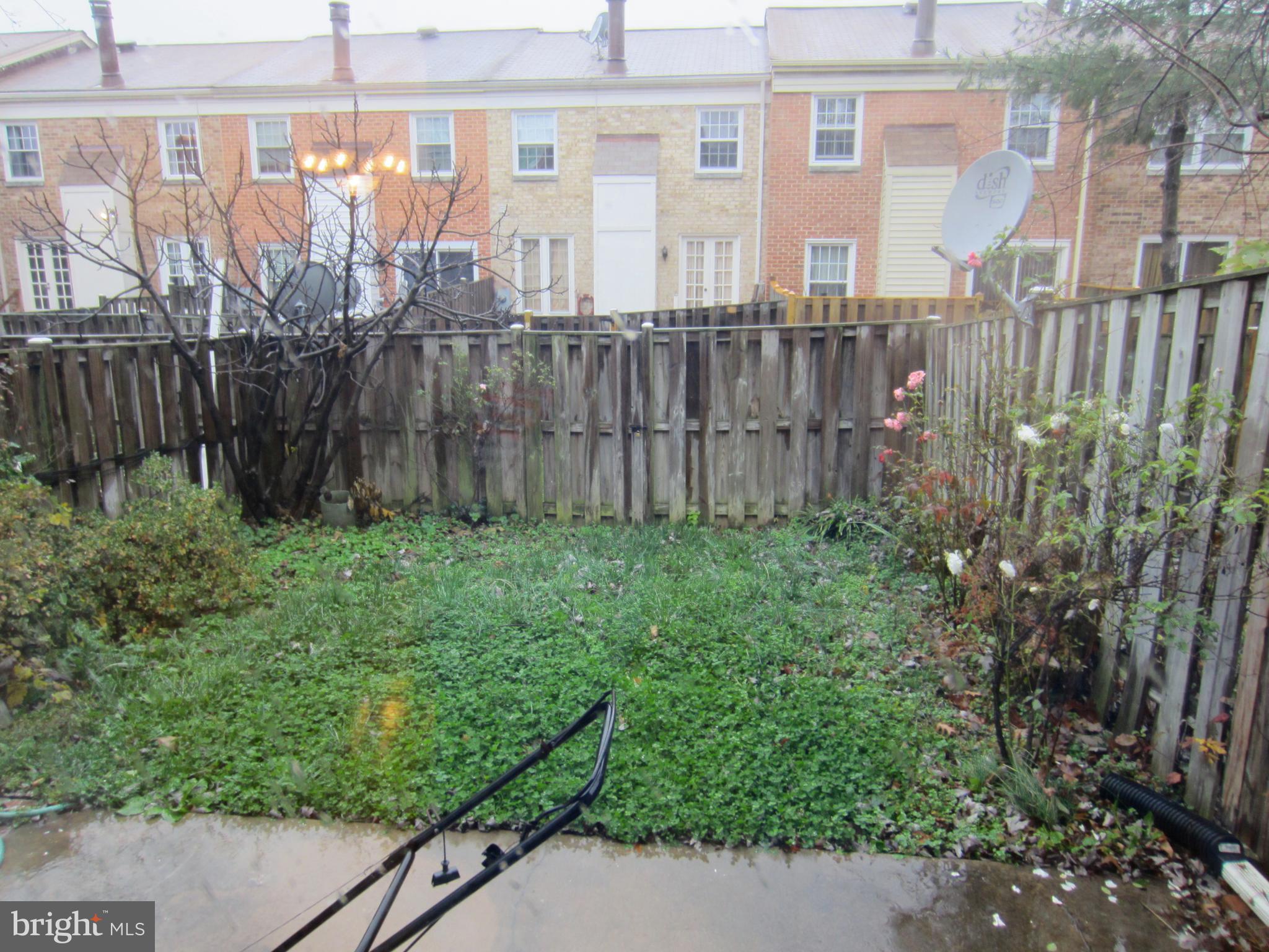 6486 Franconia Road Springfield, VA 22150 - Photo 13 of 16 a view of a backyard with large trees and wooden fence