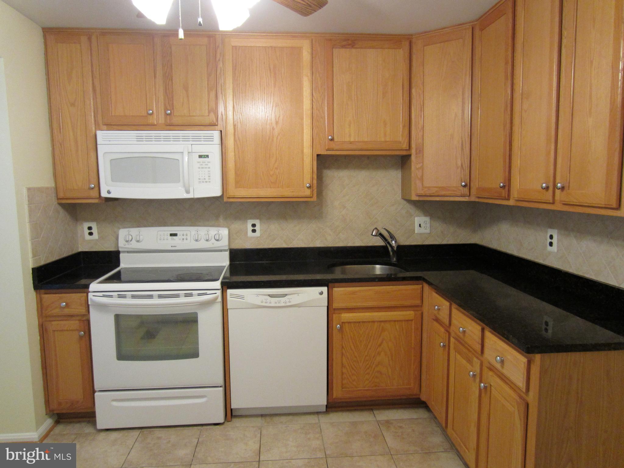 6486 Franconia Road Springfield, VA 22150 - Photo 3 of 16 a kitchen with cabinets appliances and a sink