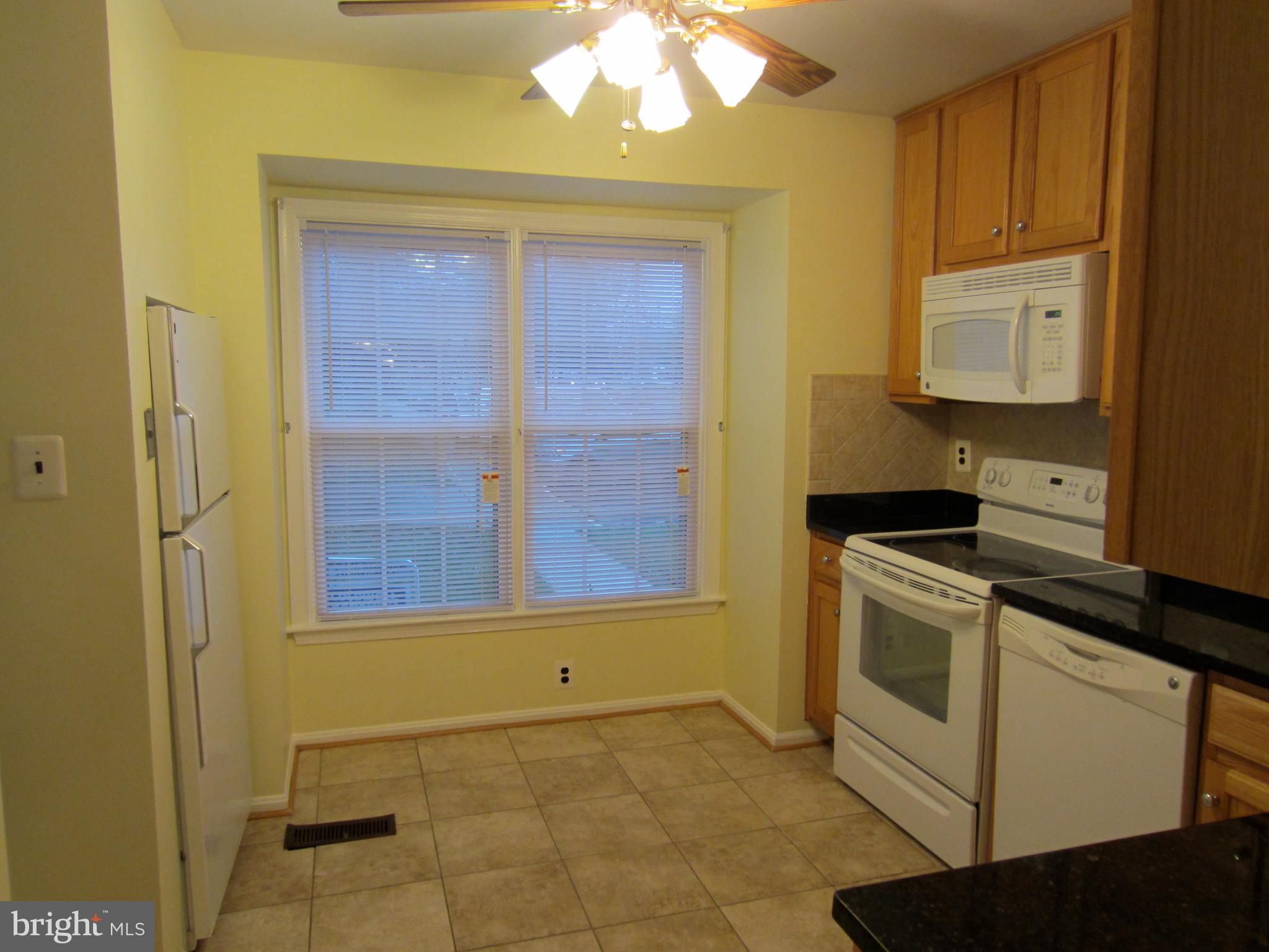 6486 Franconia Road Springfield, VA 22150 - Photo 4 of 16 a kitchen with a stove and a cabinets