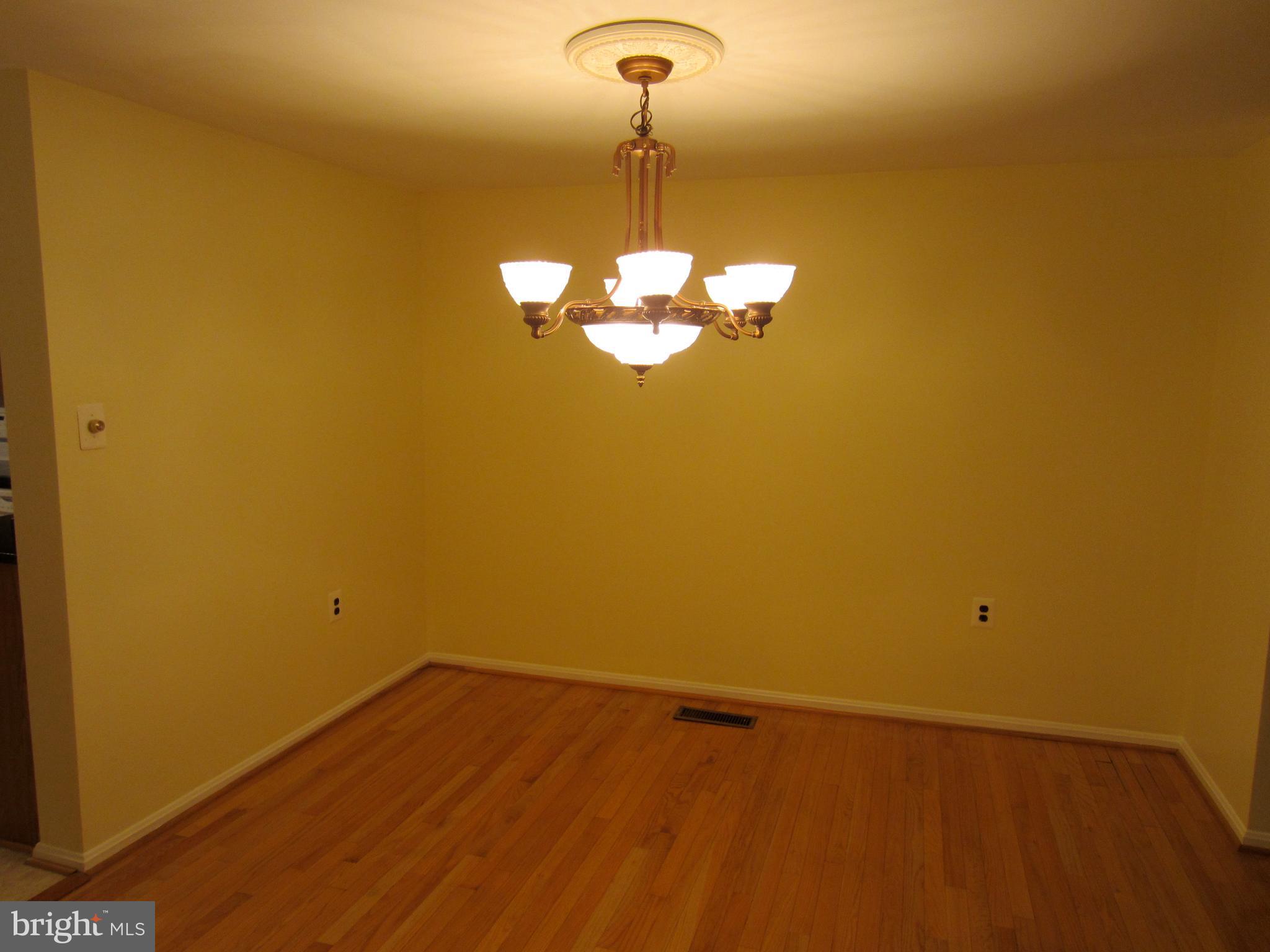 6486 Franconia Road Springfield, VA 22150 - Photo 5 of 16 a view of a room with a chandelier fan and wooden floor