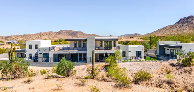 a view of a houses with a snow in the background