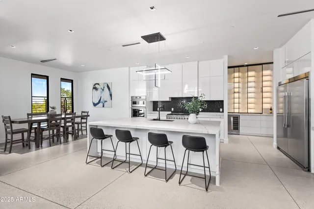 a kitchen with appliances a sink and cabinets