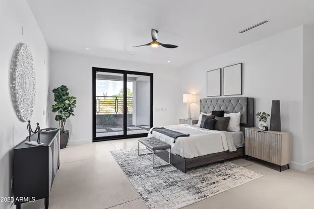 a bedroom with furniture and a large mirror