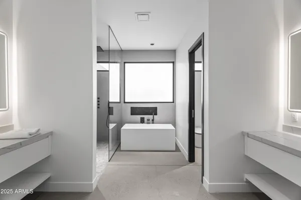 a bathroom with a sink mirror and toilet