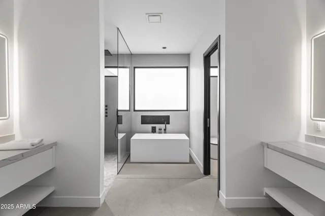 a bathroom with a sink mirror and toilet