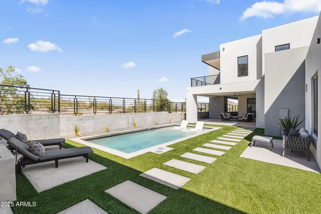 a swimming pool with outdoor seating and yard
