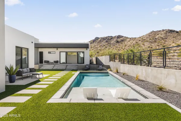 a swimming pool with outdoor seating and yard