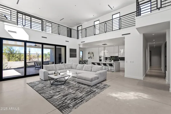a living room with furniture and large windows