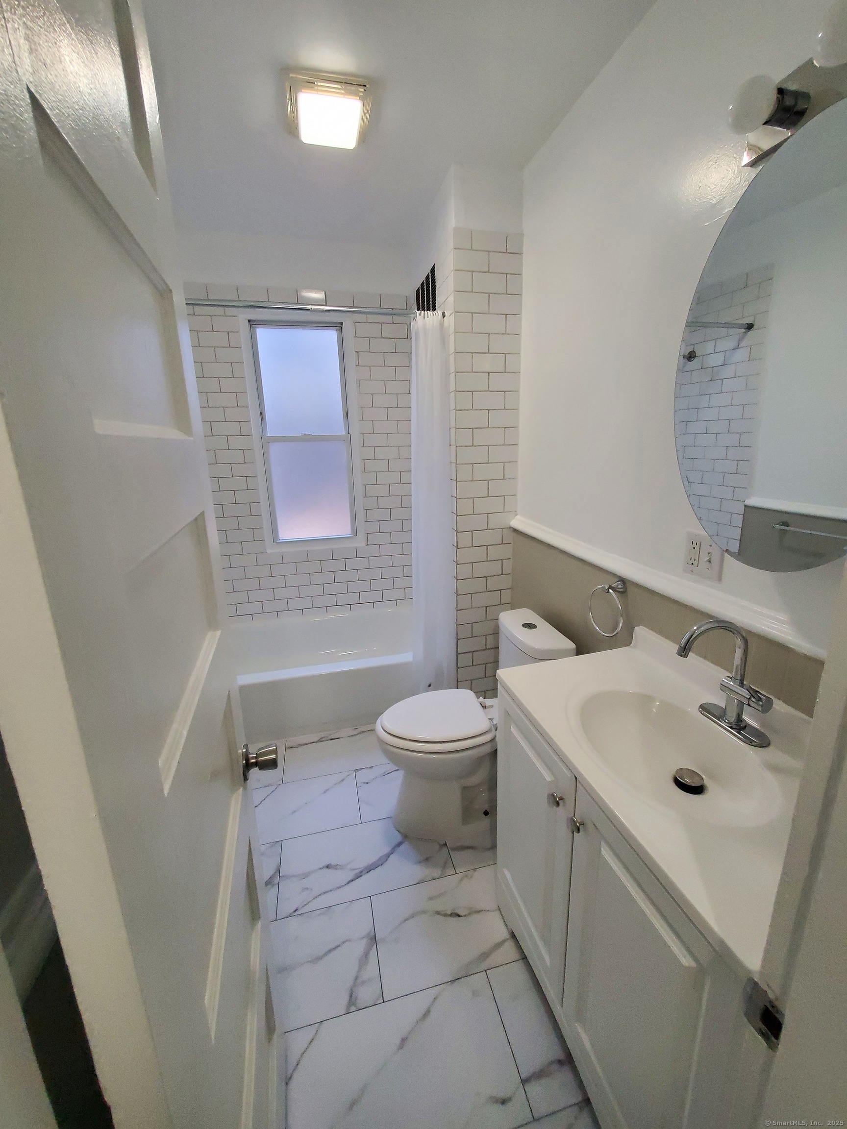 a bathroom with a sink toilet and tub