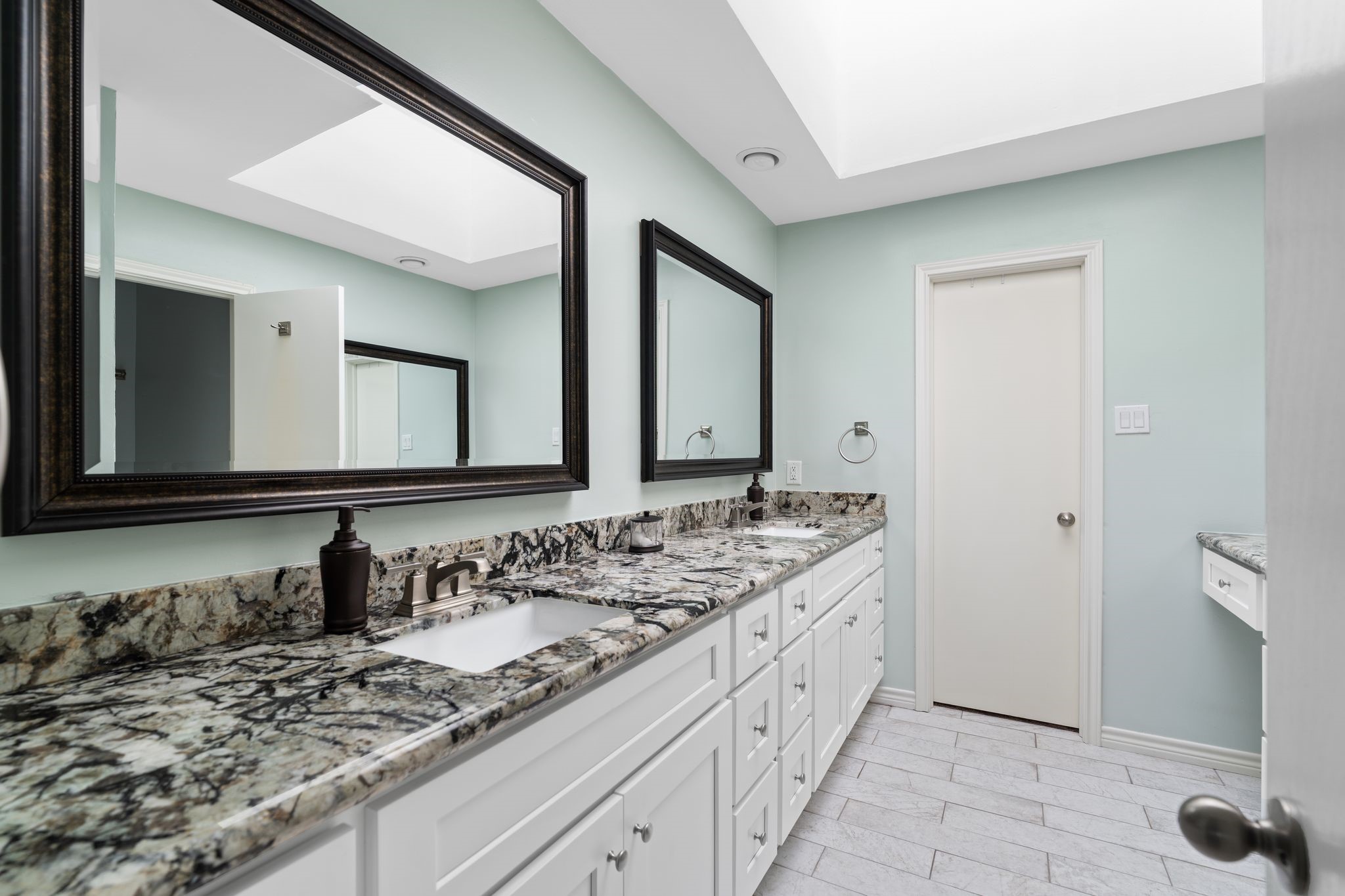 2612 Yupon Street Houston, TX 77006 - Photo 24 of 41 Primary bathroom features double sink vanity, skylight for natural light, dedicated vanity area, and access to the spacious walk in closet.