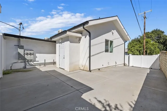 a view of a kitchen with stainless steel appliances wooden floor