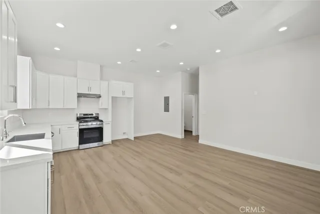 a kitchen with white cabinets and white appliances