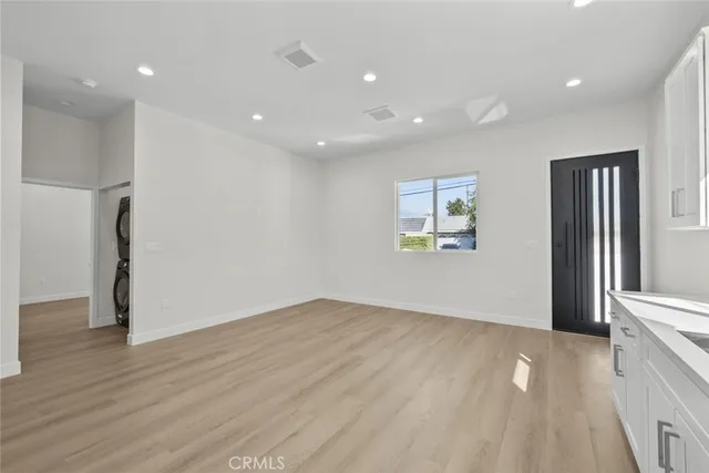 a kitchen with granite countertop white cabinets and stainless steel appliances