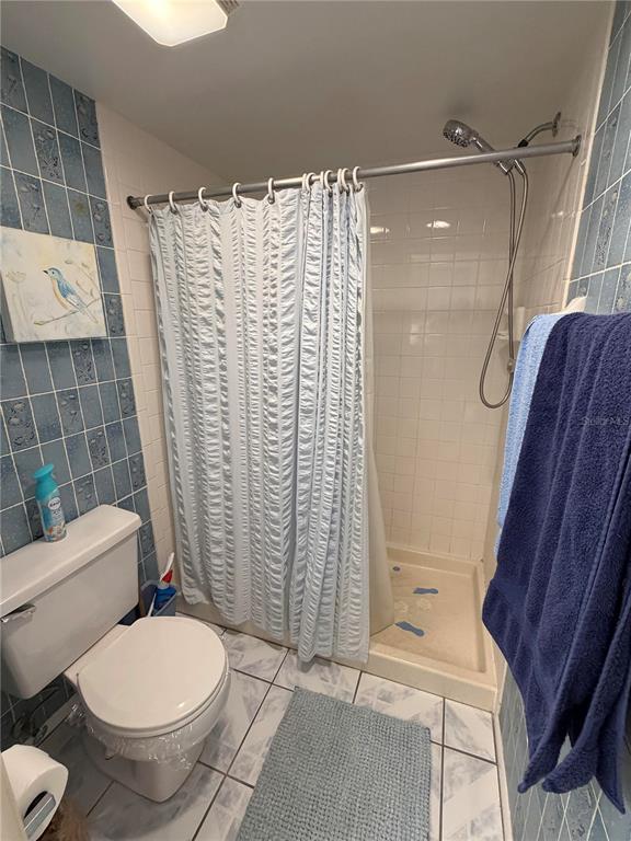 4570 Pinebrook Circle, Unit 204 Bradenton, FL 34209 - Photo 7 of 12 a bathroom with a toilet and shower