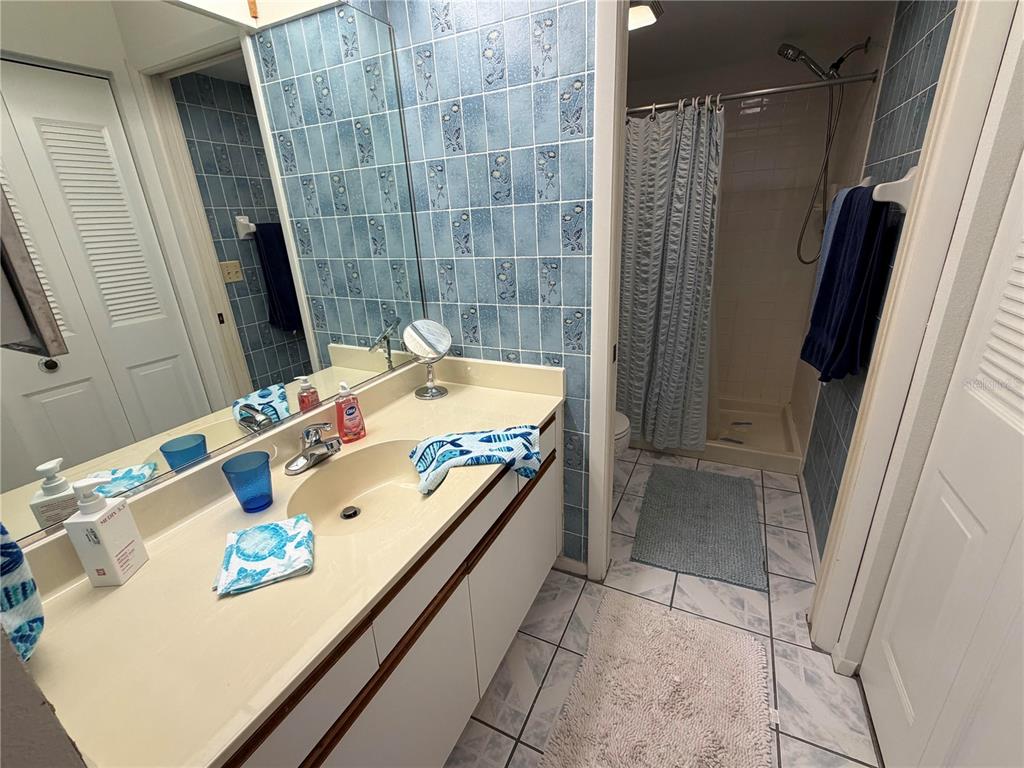 4570 Pinebrook Circle, Unit 204 Bradenton, FL 34209 - Photo 8 of 12 a bathroom with a sink a mirror and shower