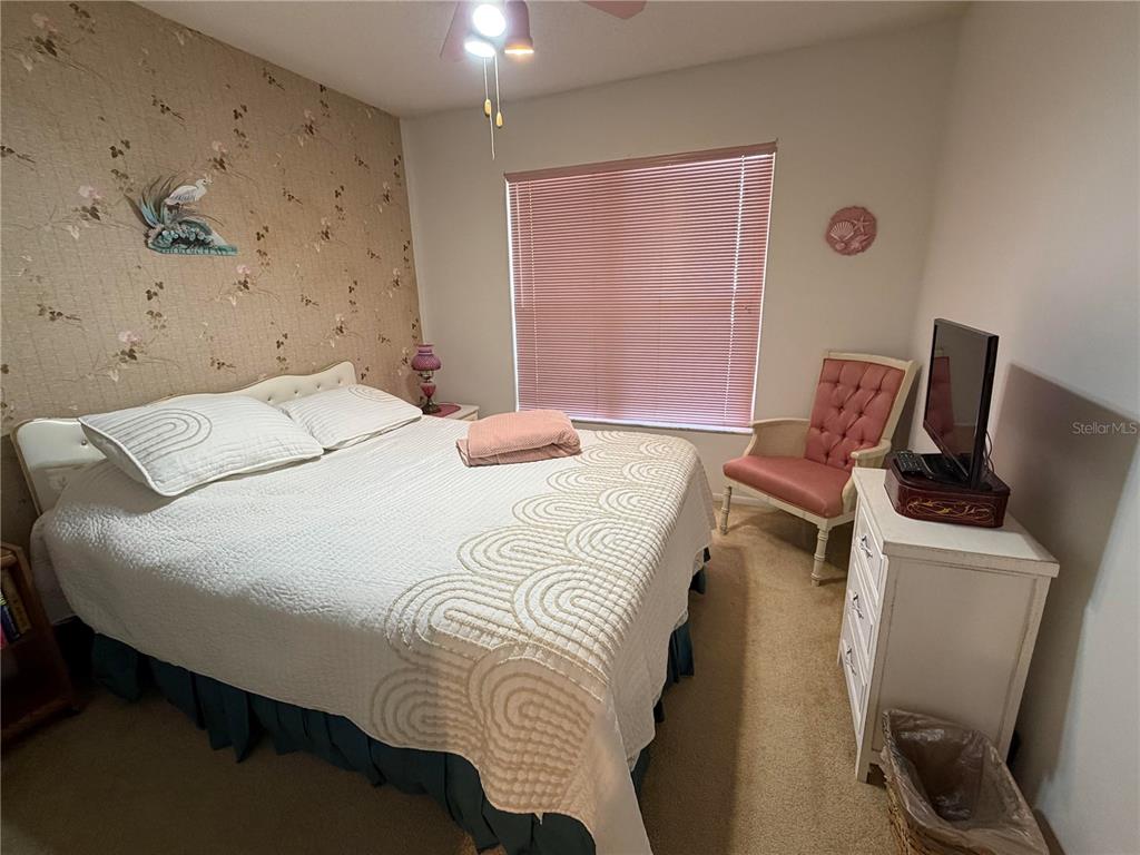 4570 Pinebrook Circle, Unit 204 Bradenton, FL 34209 - Photo 10 of 12 a bedroom with a bed and wooden floor