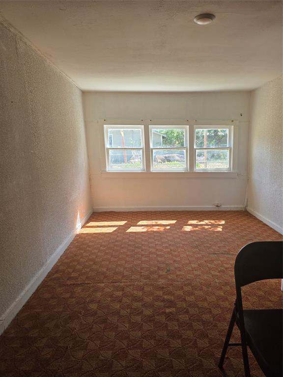 1106 6th Street Southeast Paris, TX 75460 - Photo 5 of 12 an empty room with a window