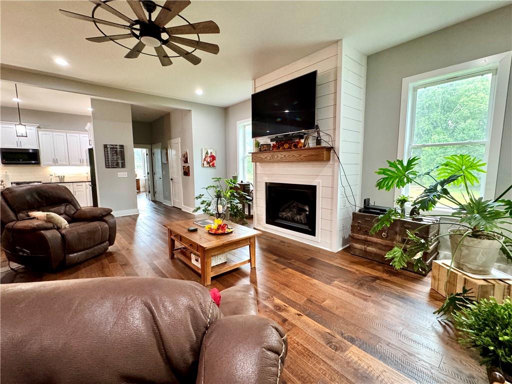 250 Hook Road Northeast Ranger, GA 30734 - Photo 42 of 114 a living room with furniture a flat screen tv and a fireplace
