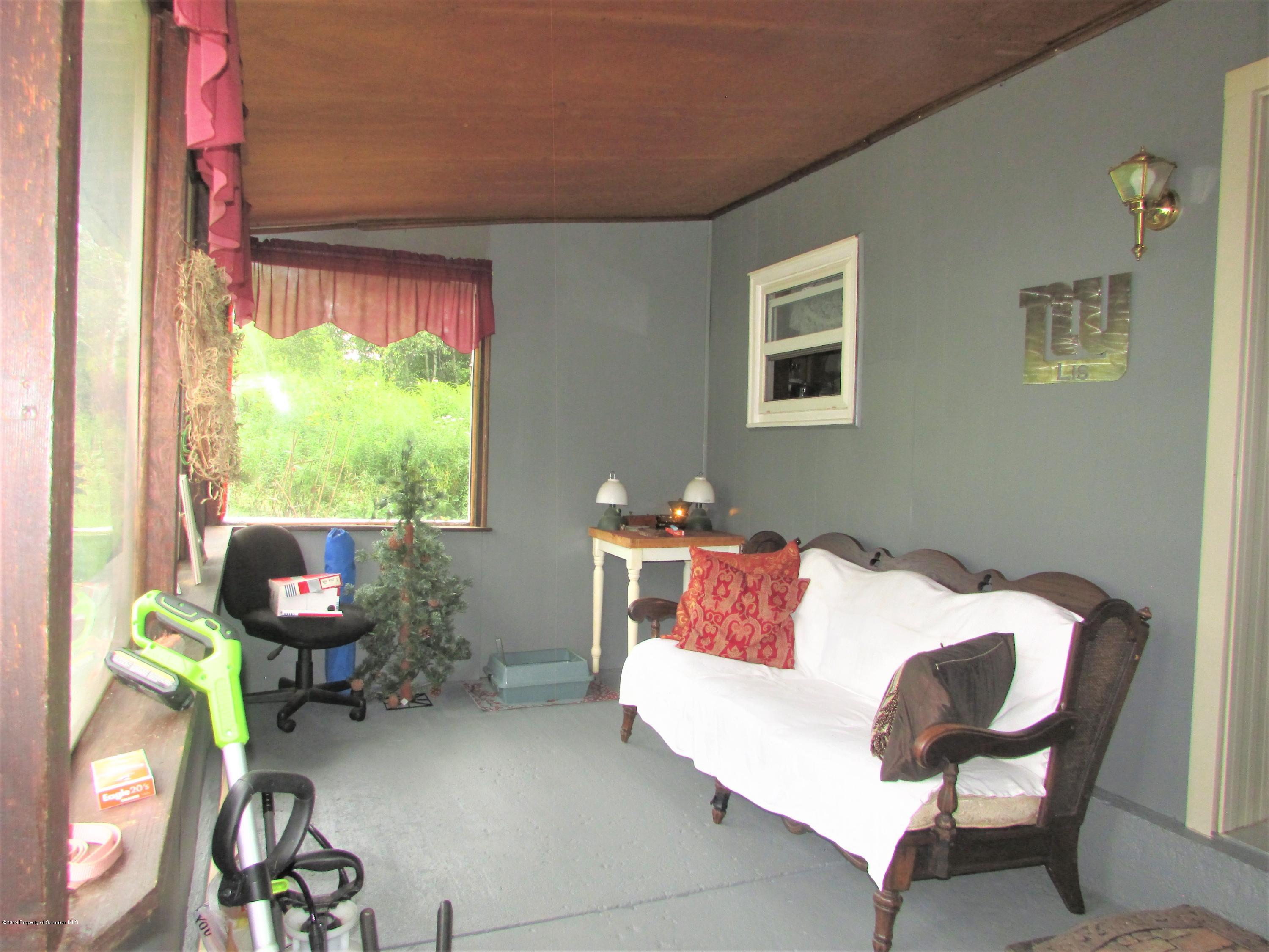 859 Flanagan Road Wyalusing, PA 18853 - Photo 12 of 19 a living room with furniture and a window
