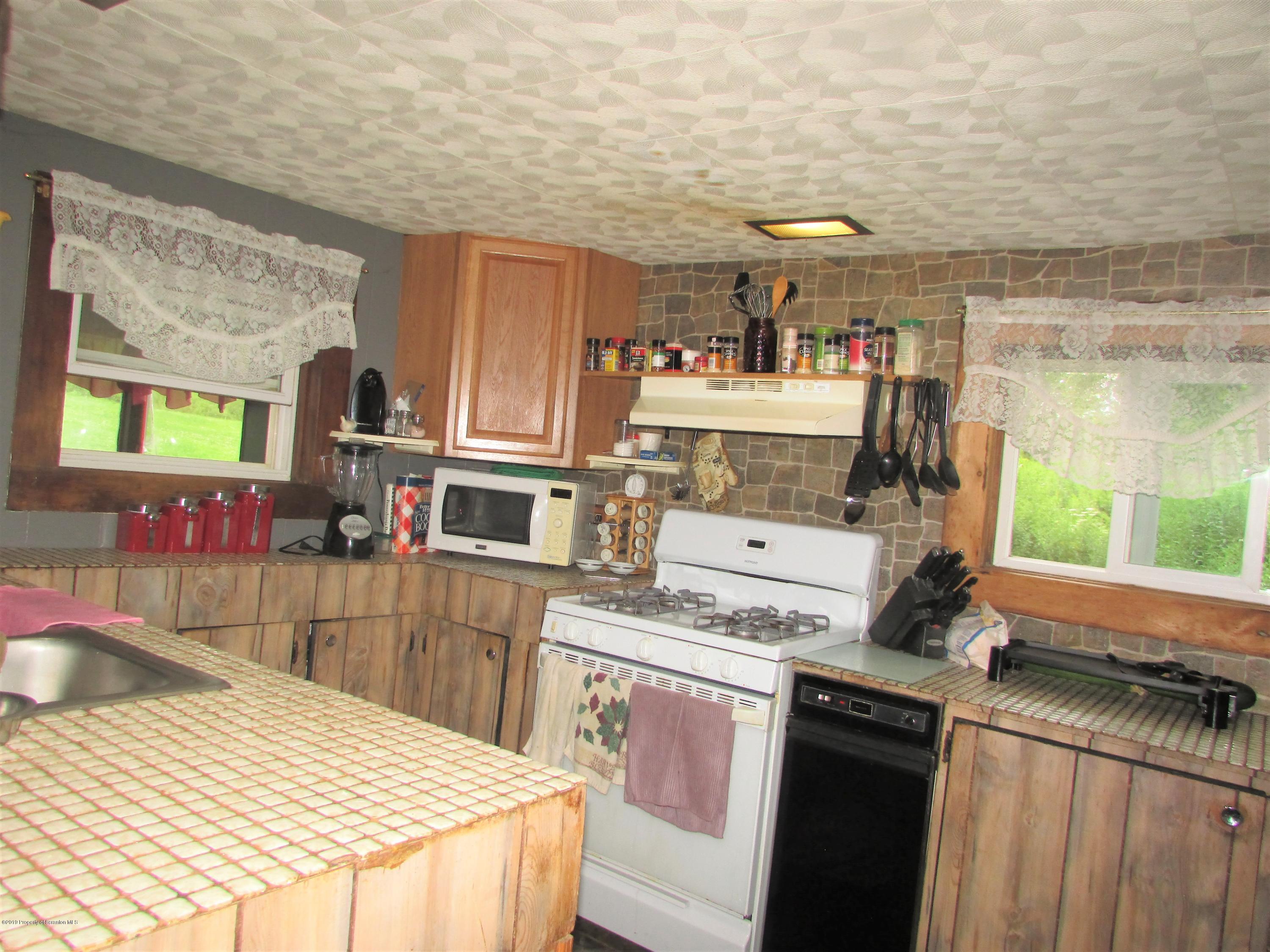 859 Flanagan Road Wyalusing, PA 18853 - Photo 3 of 19 a kitchen that has a sink and a stove