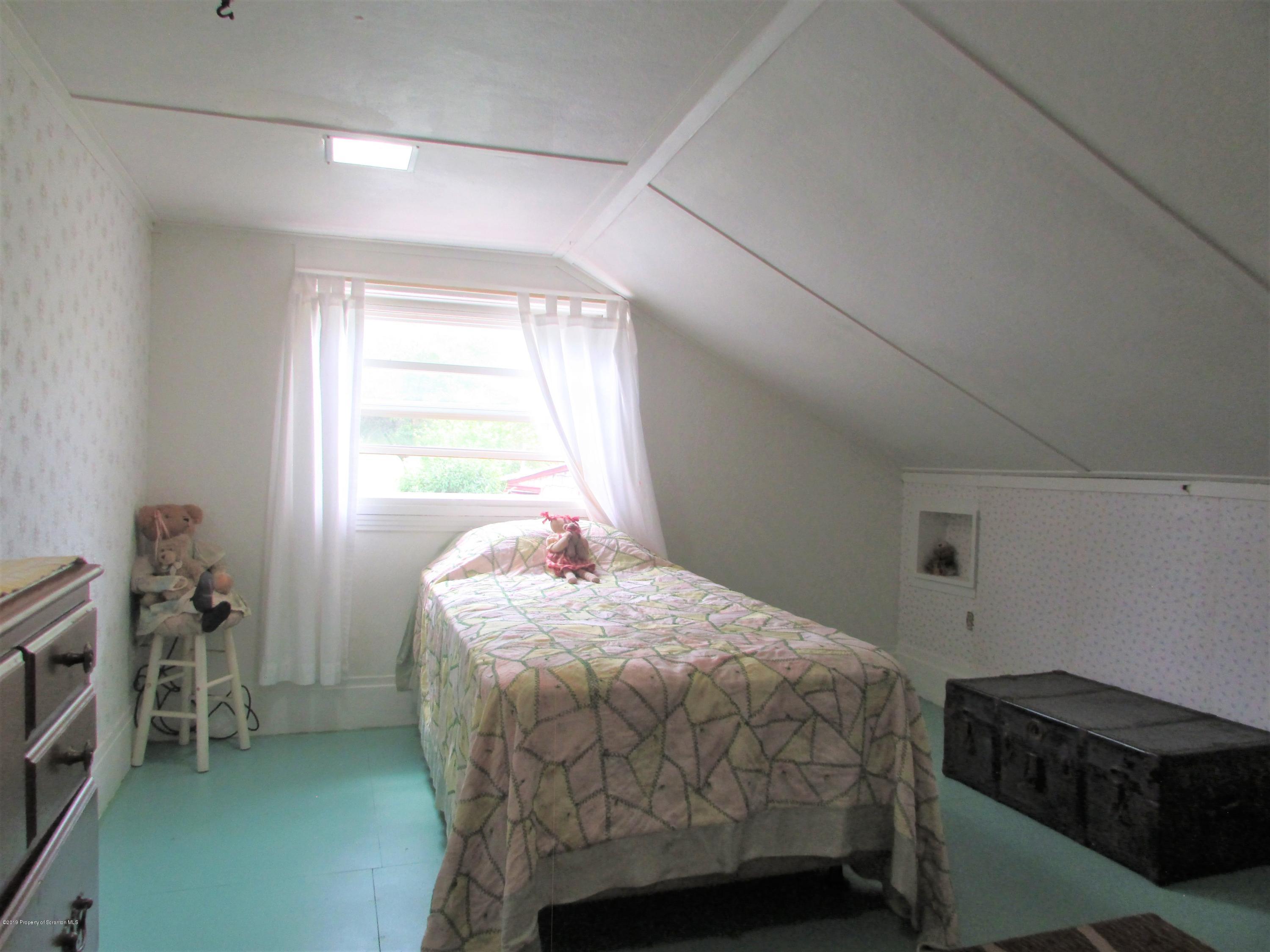 859 Flanagan Road Wyalusing, PA 18853 - Photo 8 of 19 a bedroom with a bed and a window