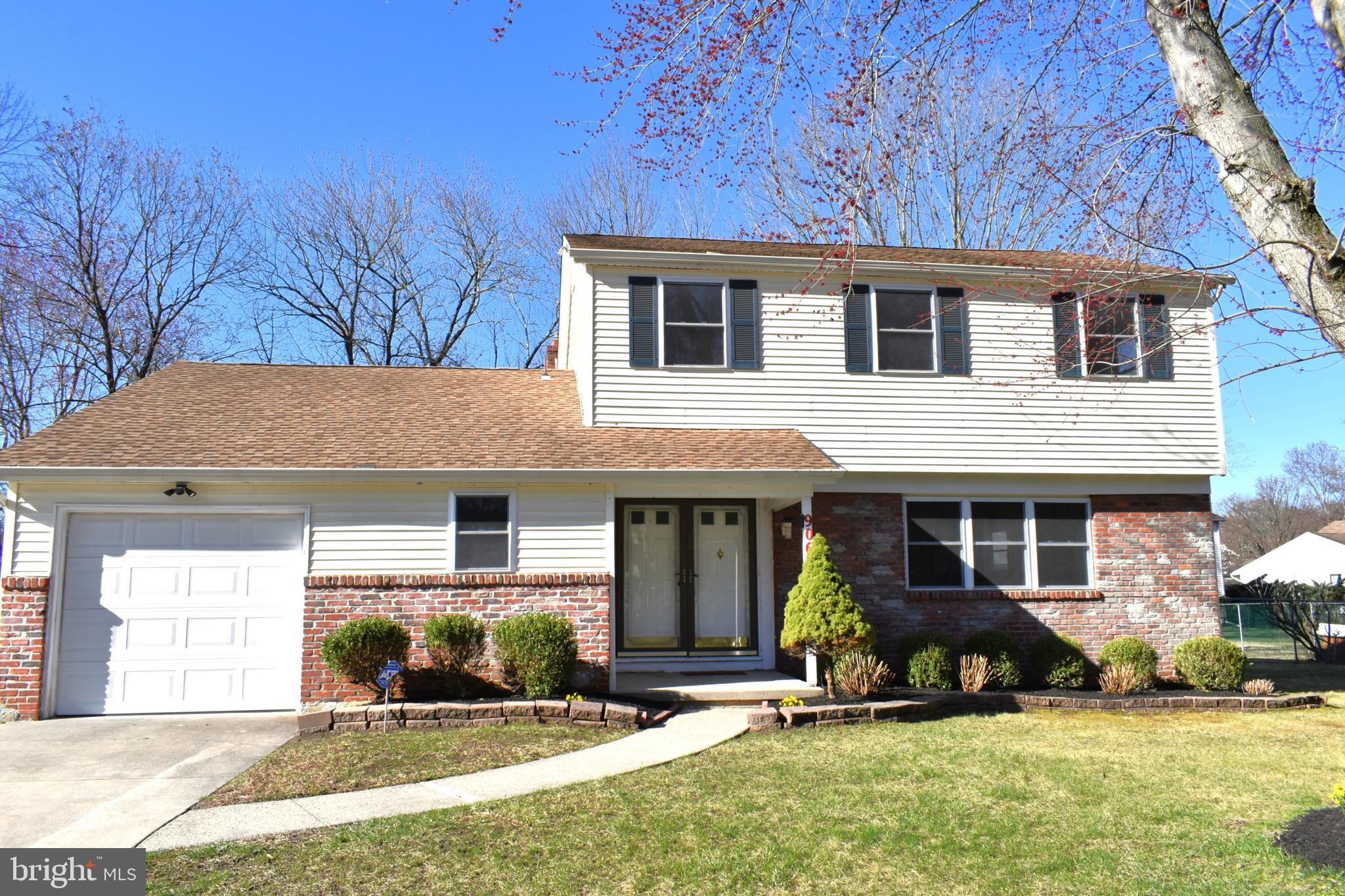 a front view of a house with a yard outdoor seating and garage