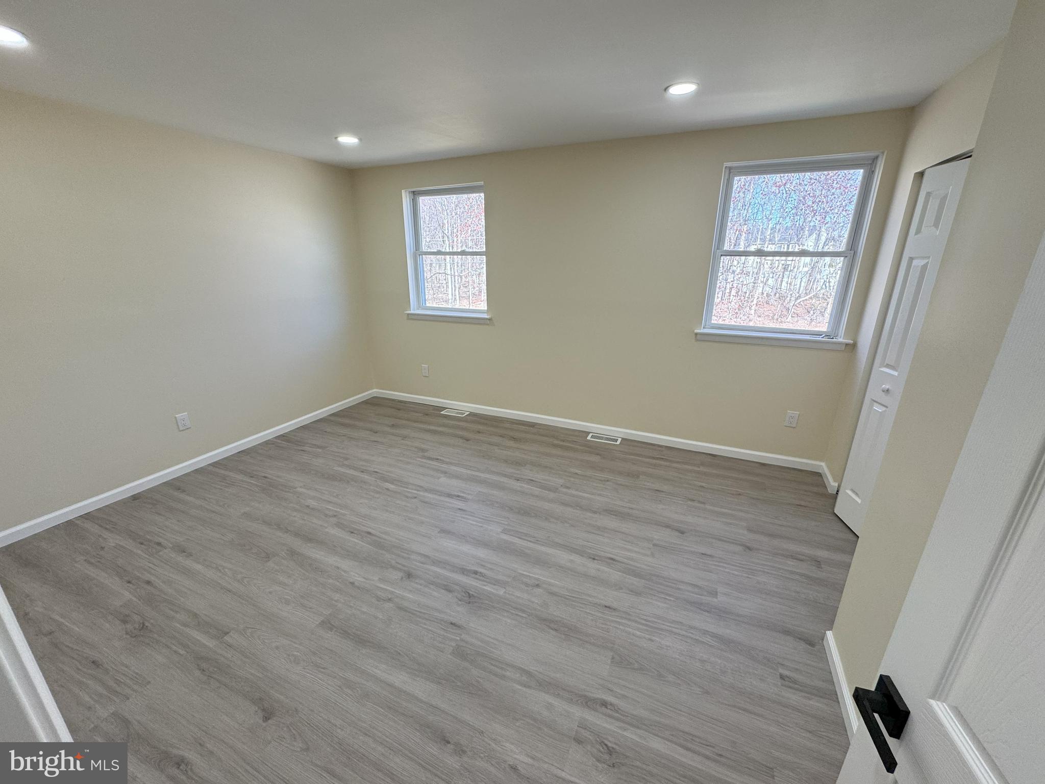 906 Marlowe Road Cherry Hill, NJ 08003 - Photo 33 of 38 an empty room with wooden floor and windows