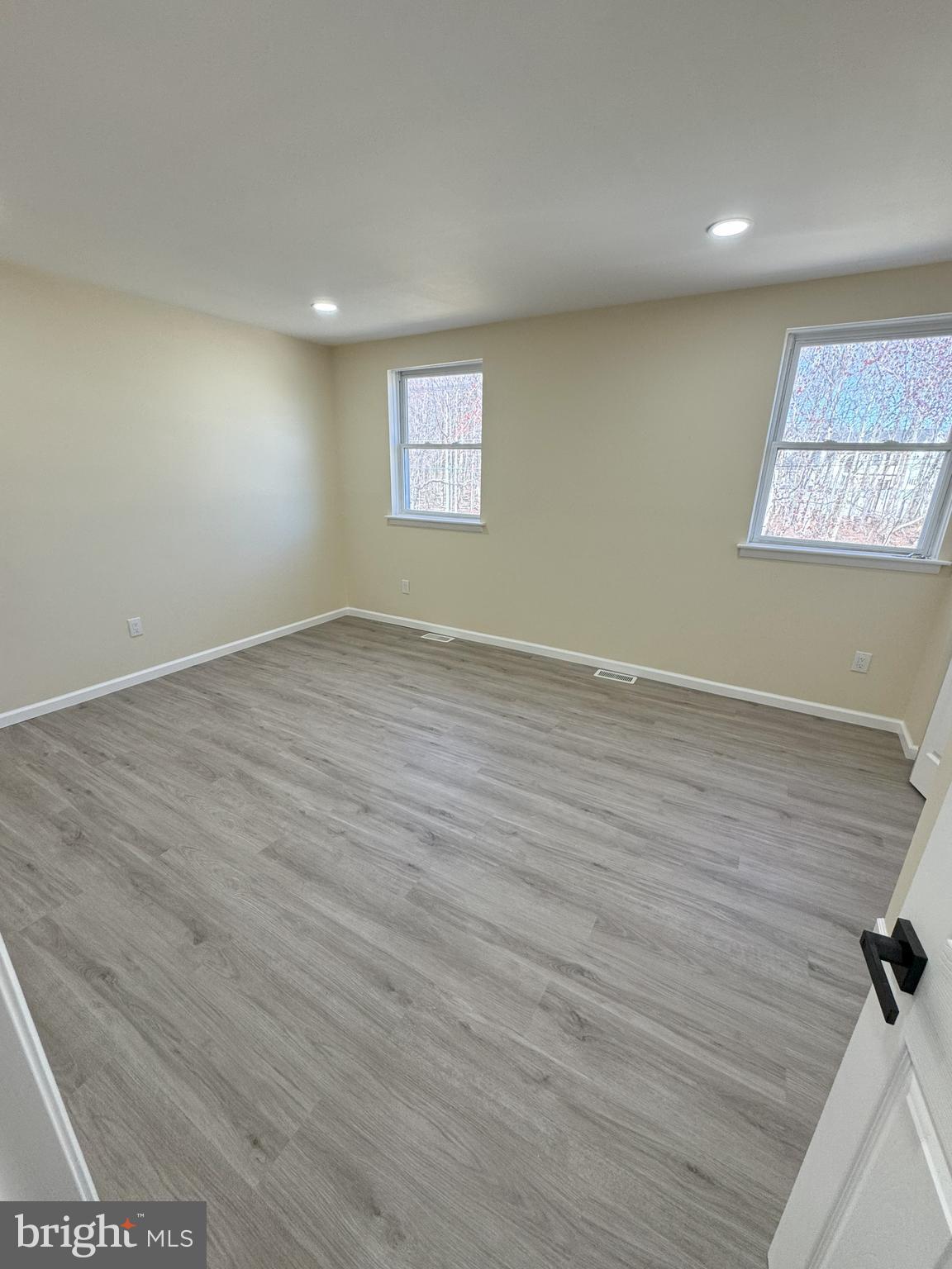 906 Marlowe Road Cherry Hill, NJ 08003 - Photo 34 of 38 an empty room with wooden floor and windows