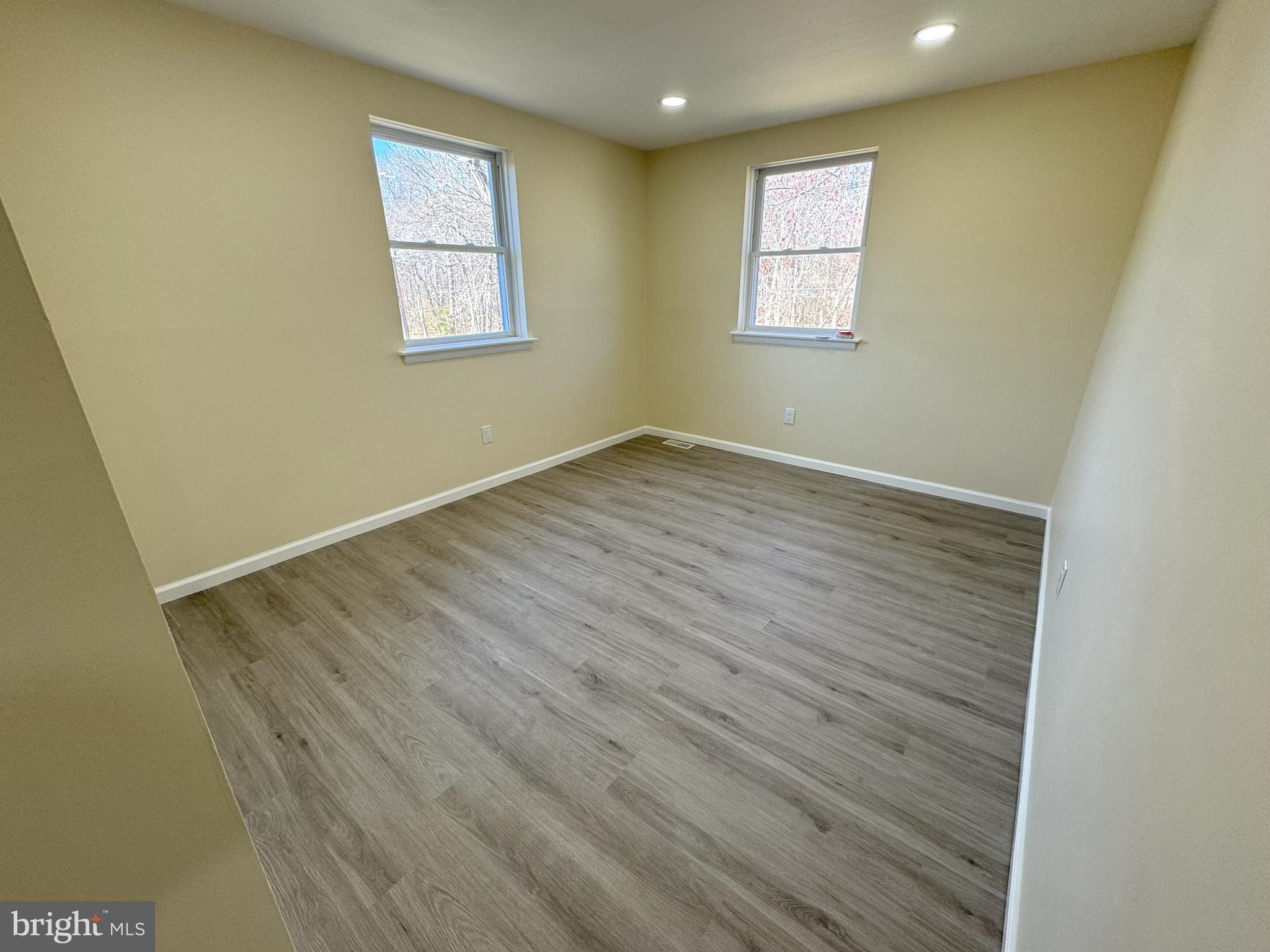 906 Marlowe Road Cherry Hill, NJ 08003 - Photo 35 of 38 an empty room with wooden floor and windows