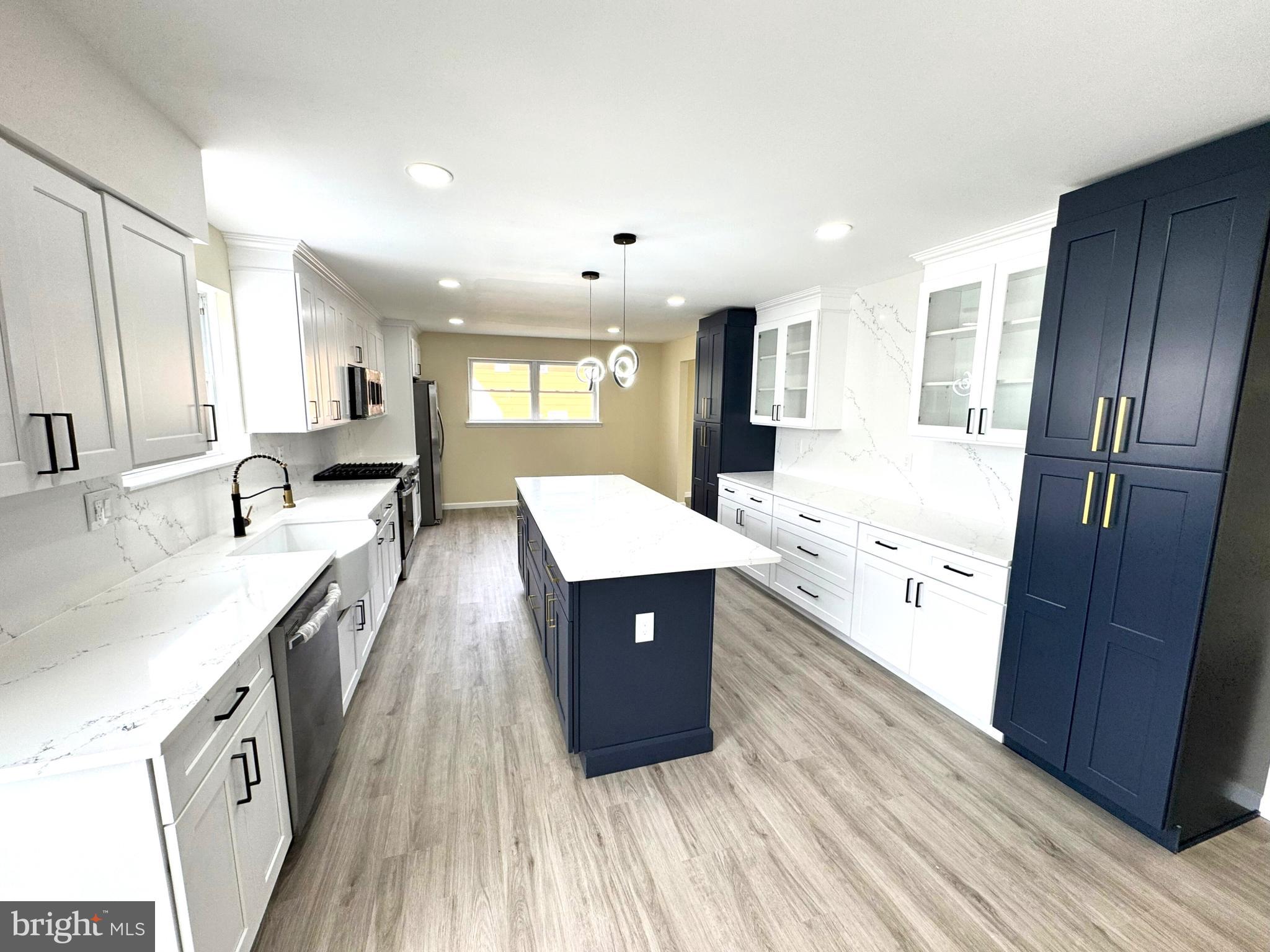 906 Marlowe Road Cherry Hill, NJ 08003 - Photo 8 of 38 a large kitchen with stainless steel appliances sink a microwave and cabinets