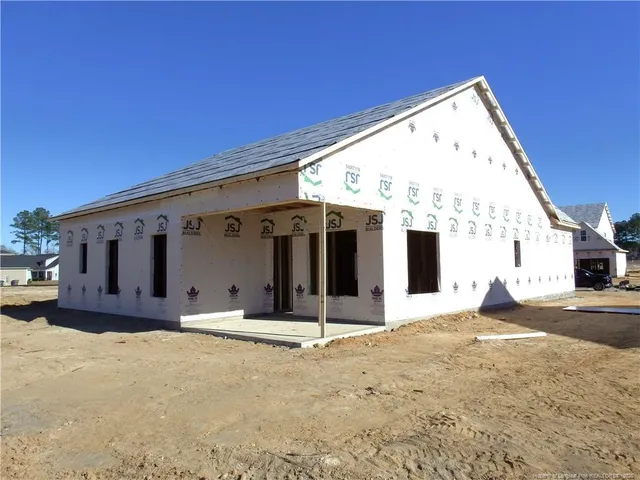 a view of a house with wooden wall and a large window
