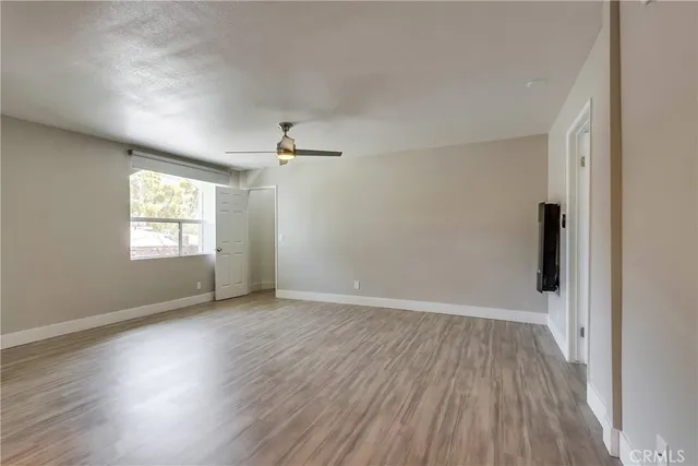 a view of wooden floor and windows in a room