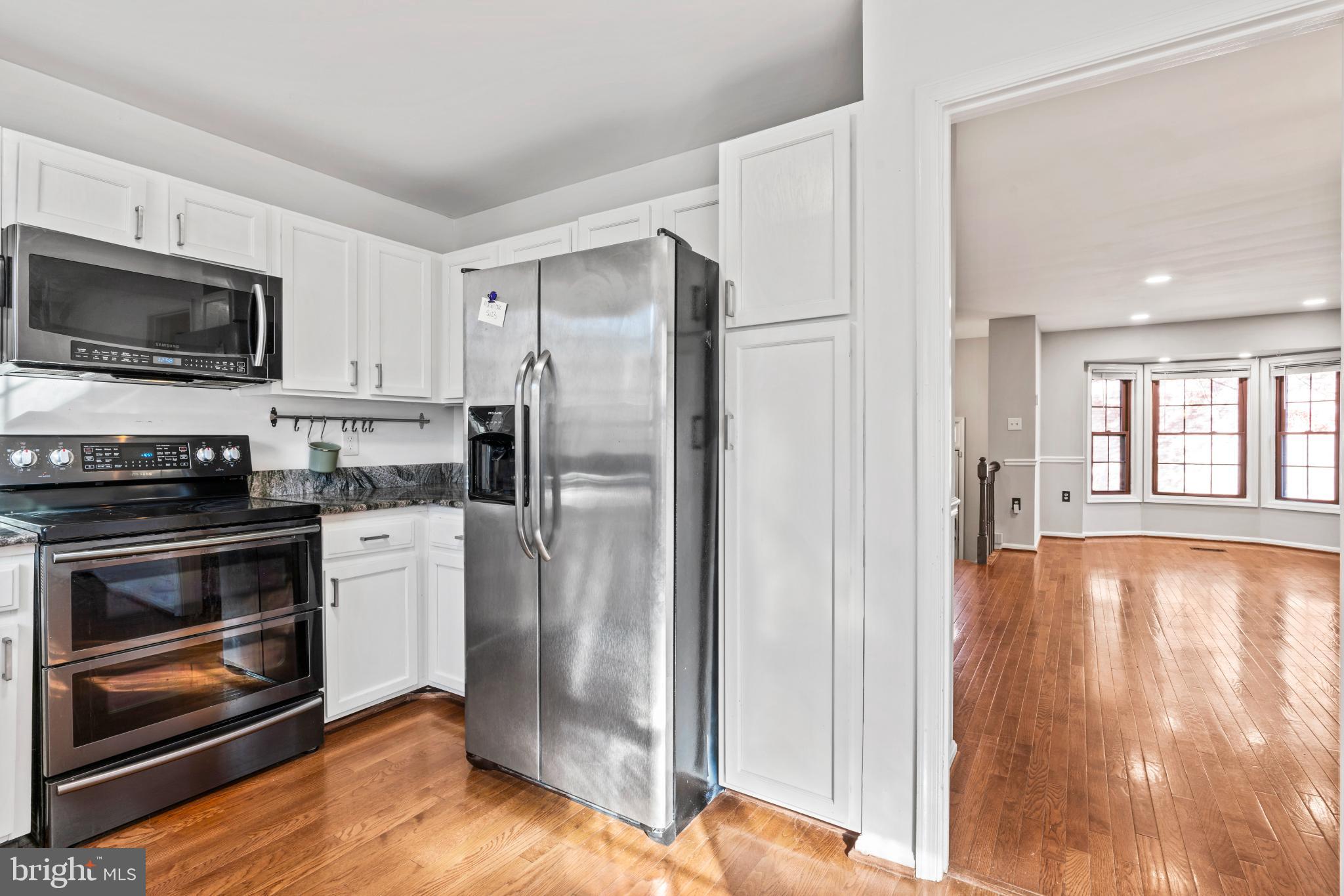5416 Wycklow Court Alexandria, VA 22304 - Photo 11 of 46 a kitchen with granite countertop a refrigerator stove and microwave