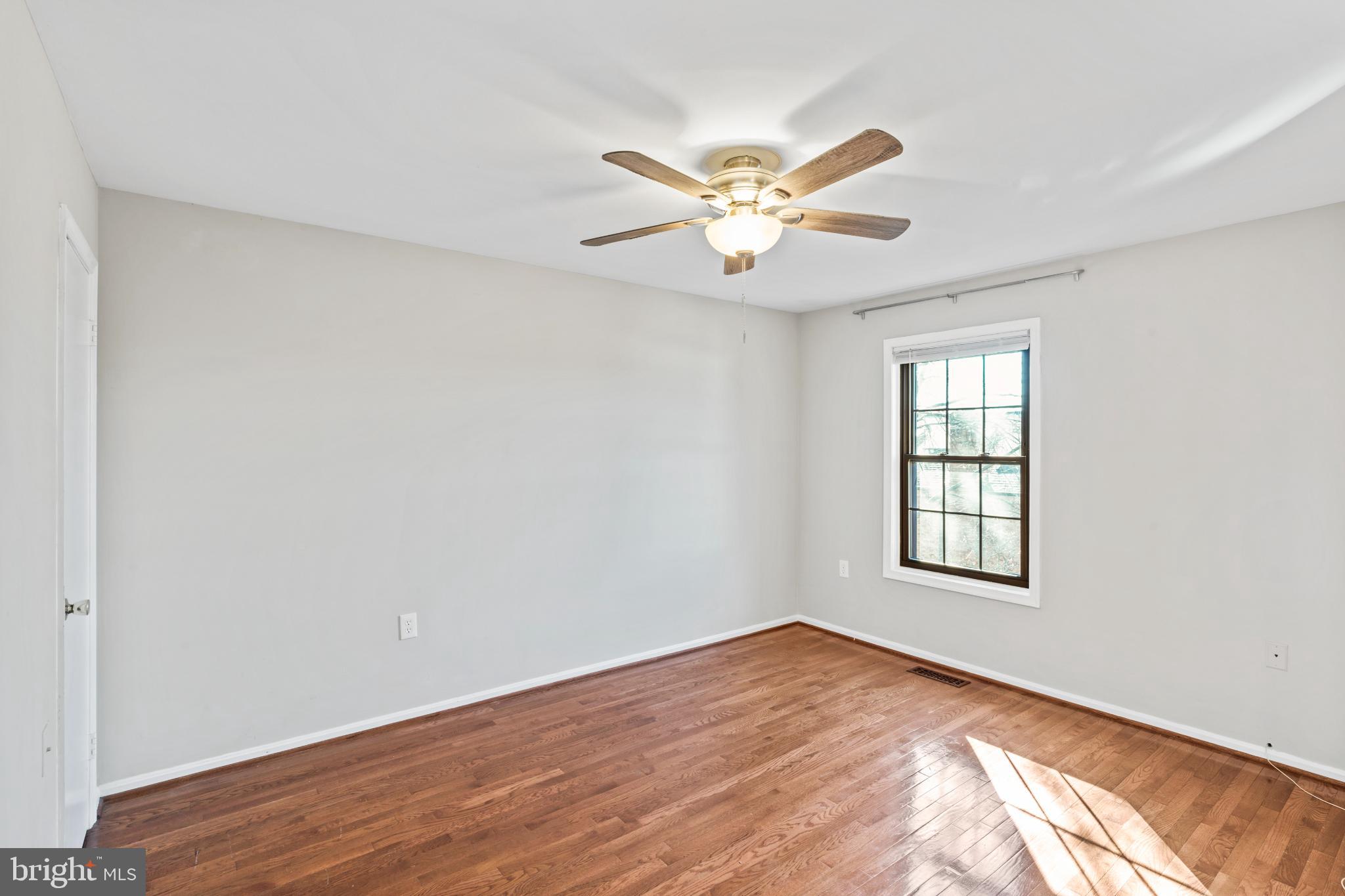 5416 Wycklow Court Alexandria, VA 22304 - Photo 14 of 46 a view of an empty room with wooden floor and a window