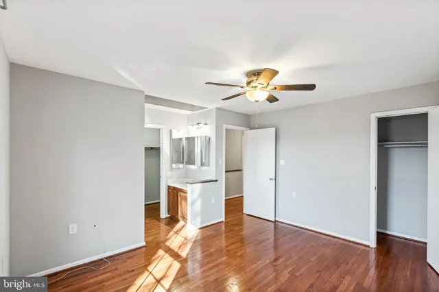 a view of empty room with wooden floor