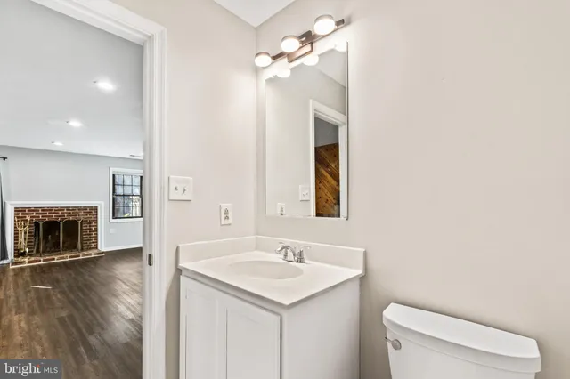 a bathroom with a sink a toilet and a mirror