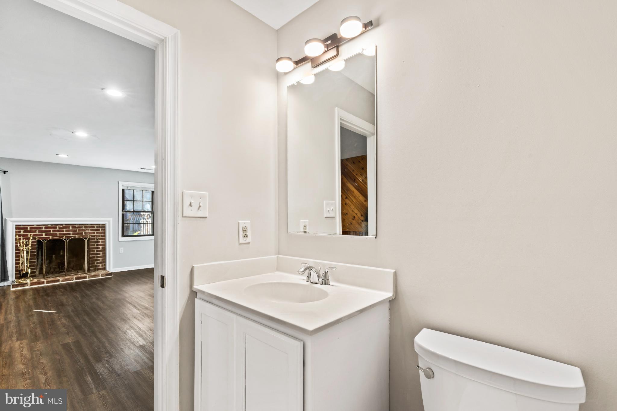 5416 Wycklow Court Alexandria, VA 22304 - Photo 36 of 46 a bathroom with a sink a toilet and a mirror