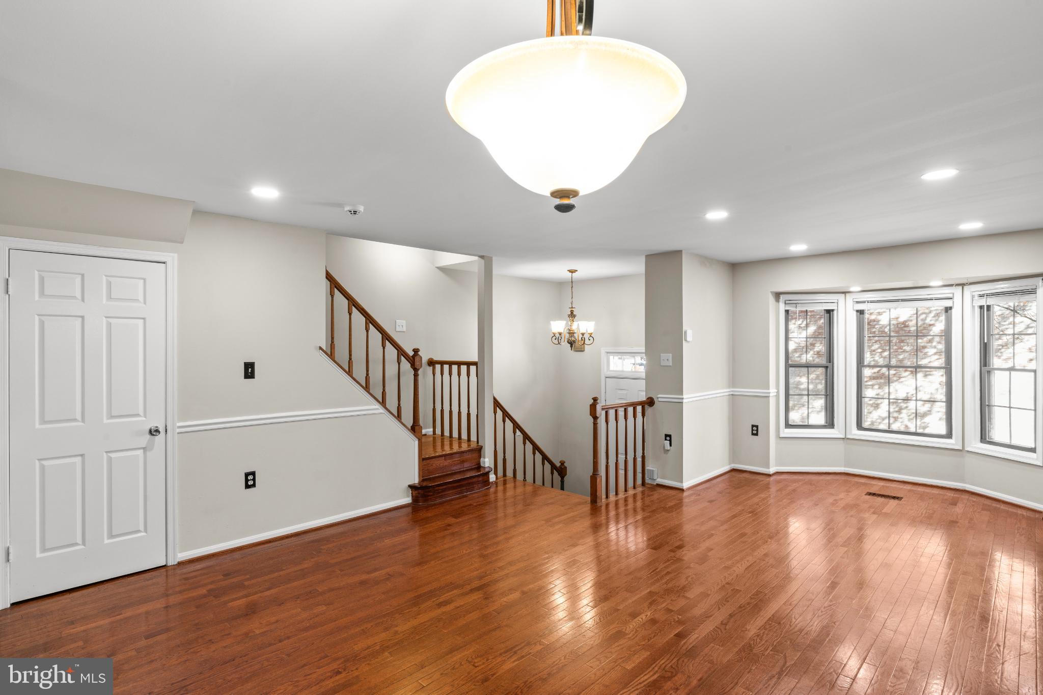 5416 Wycklow Court Alexandria, VA 22304 - Photo 4 of 46 a view of an empty room with wooden floor and a window