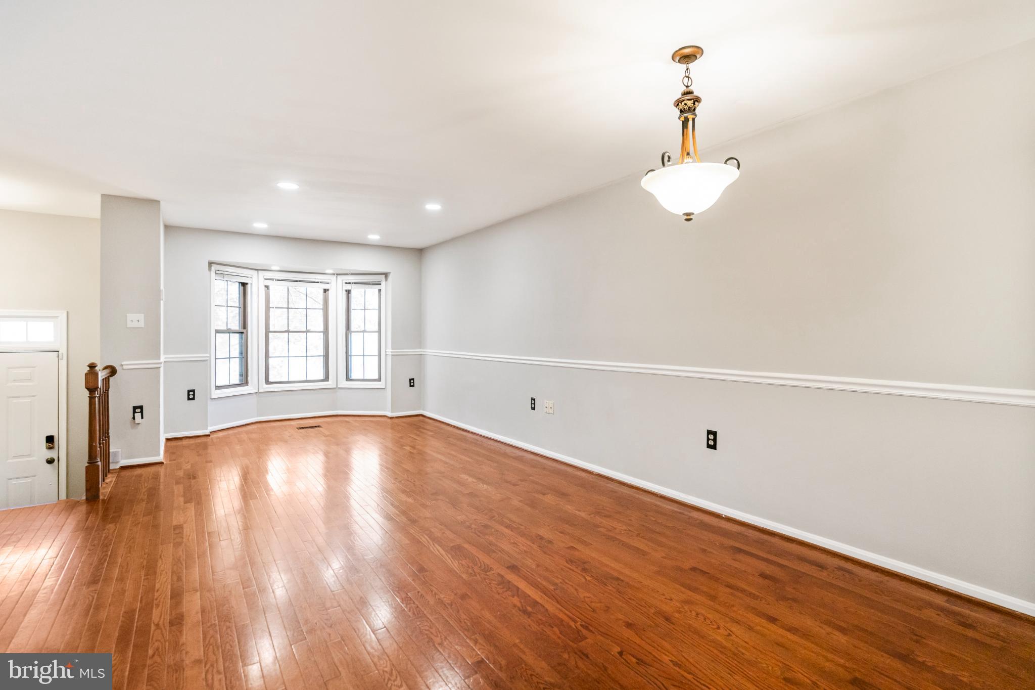 5416 Wycklow Court Alexandria, VA 22304 - Photo 5 of 46 a view of an empty room with wooden floor and a window