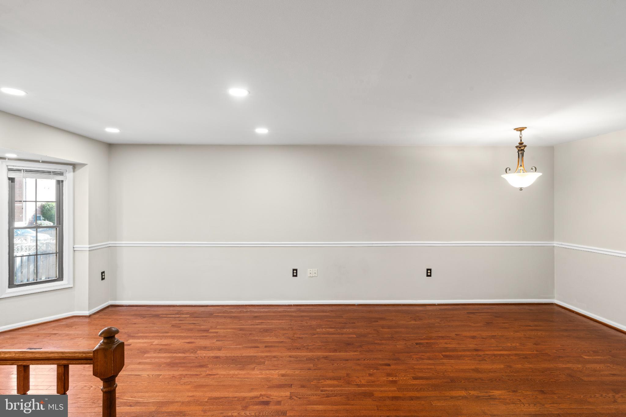 5416 Wycklow Court Alexandria, VA 22304 - Photo 6 of 46 a view of an empty room with wooden floor and a window