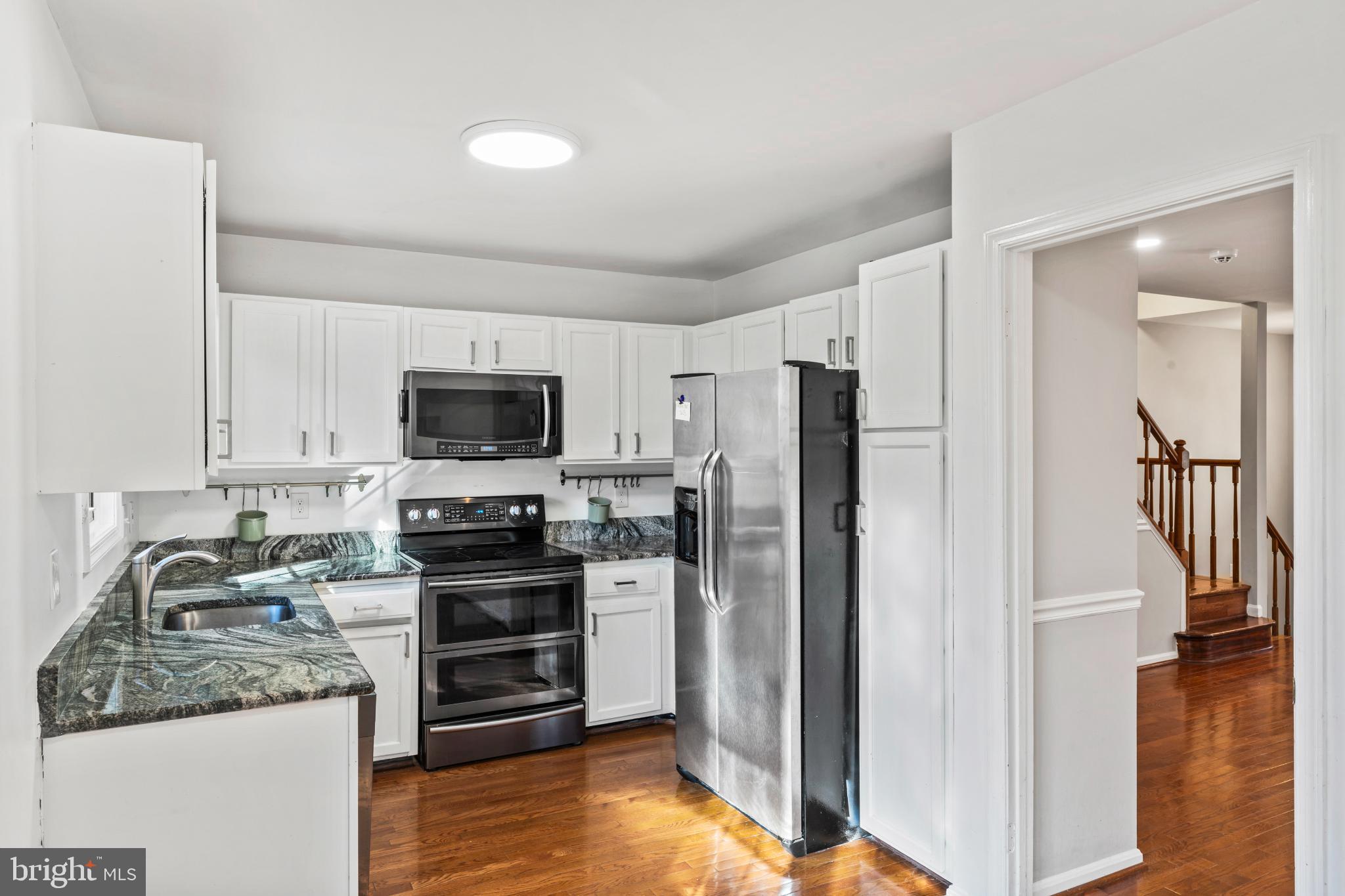 5416 Wycklow Court Alexandria, VA 22304 - Photo 9 of 46 a kitchen with stainless steel appliances granite countertop a refrigerator and a stove top oven
