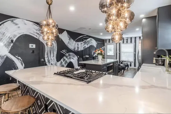 a view of a dining room with furniture and chandelier