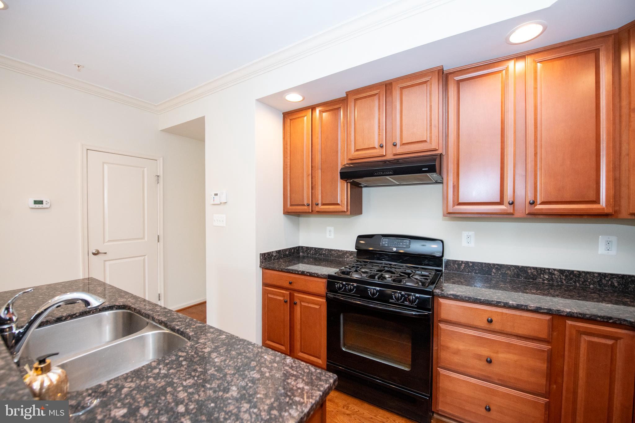 306 Mill Pond Road, Unit A Frederick, MD 21701 - Photo 12 of 31 Kitchen overlooking half bath and garage entry