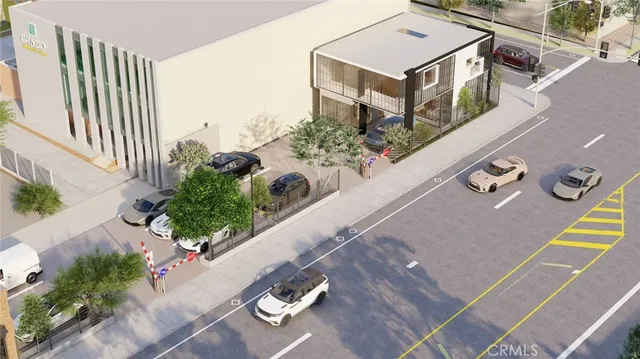 an aerial view of a house with garden space and street view