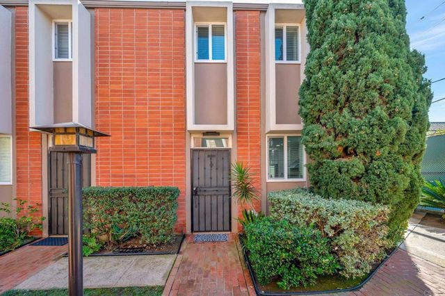 a living room with furniture a window and wooden floor