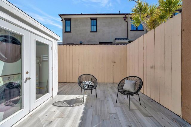 a backyard of a house with table and chairs